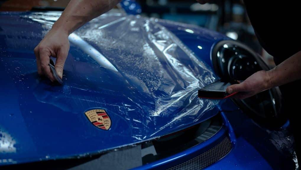 Blue Porsche being wrapped - Pazi Performance Collision Repair Services Blue Porsche being wrapped - Pazi Performance Collision Repair Services